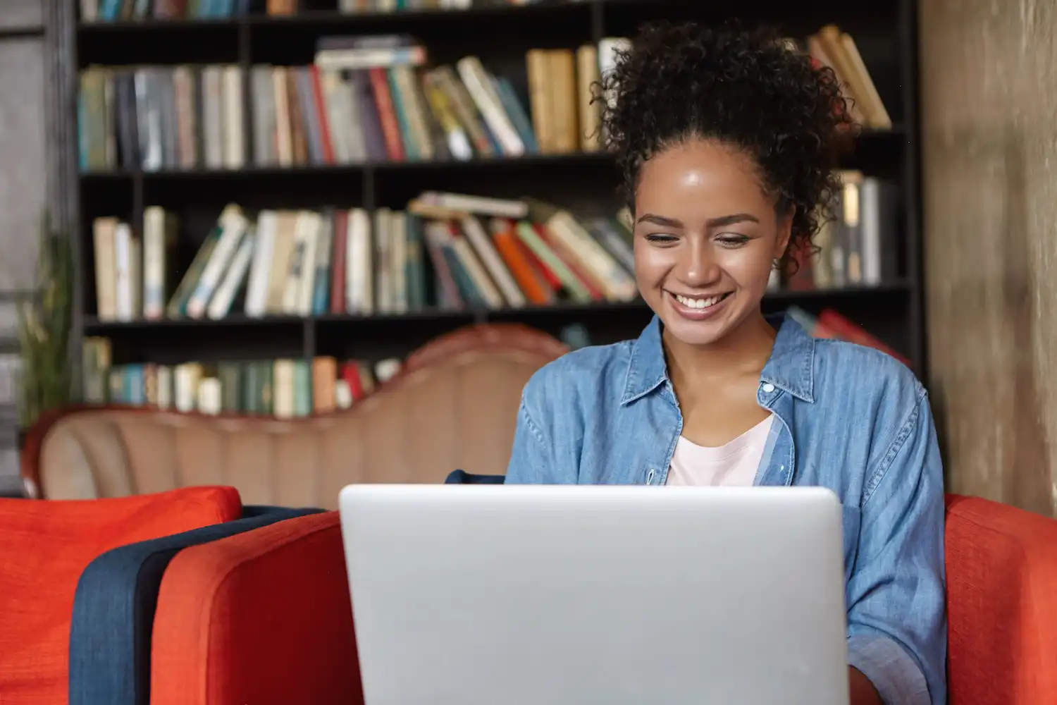 woman-sitting-library-with-her-laptop